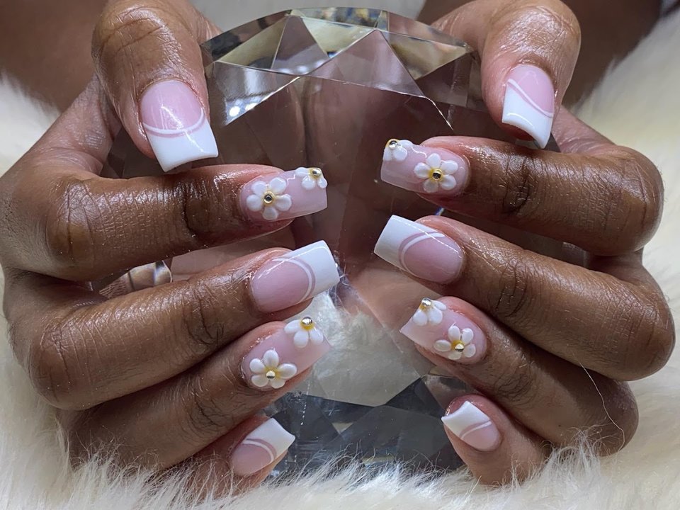 Manicured hands with glossy pink nails.
