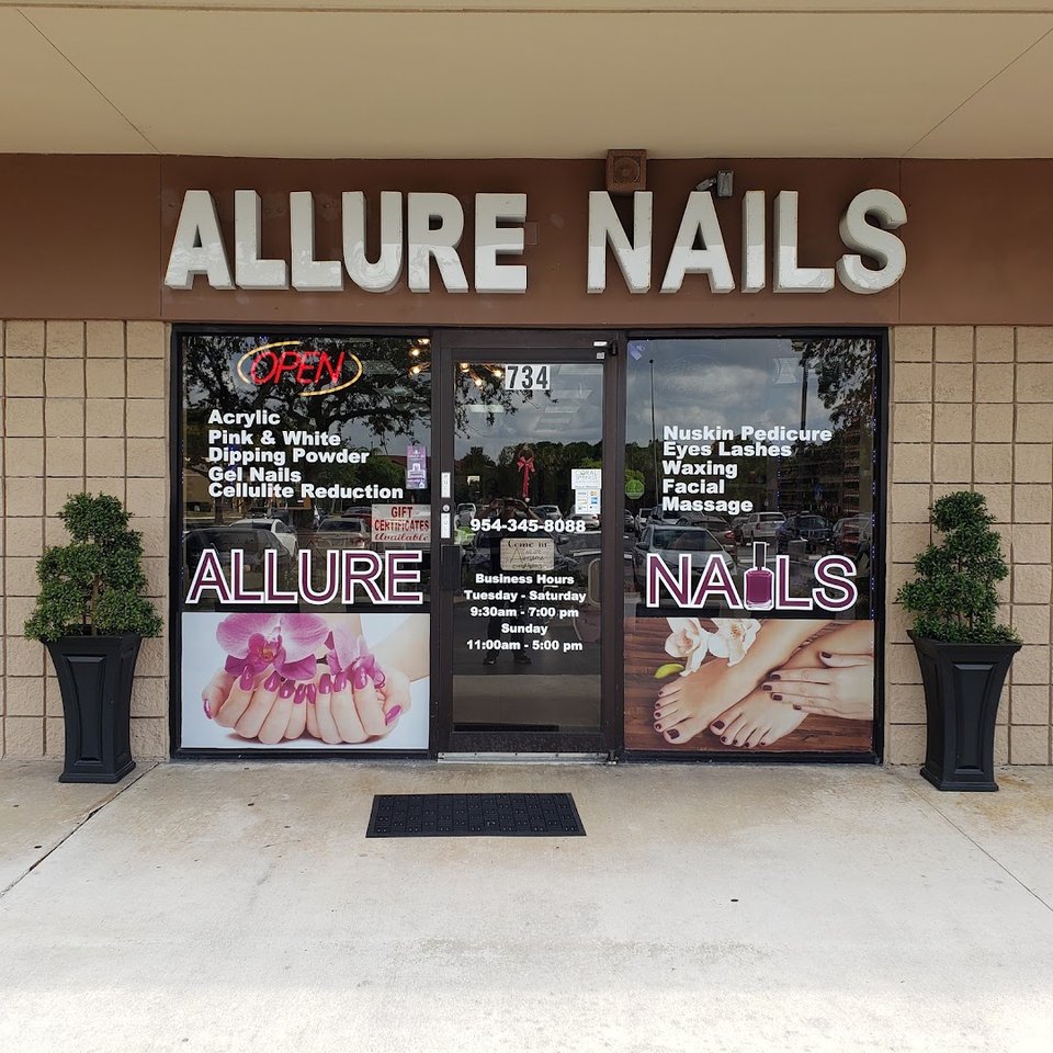 Manicured hands with glossy pink nails.
